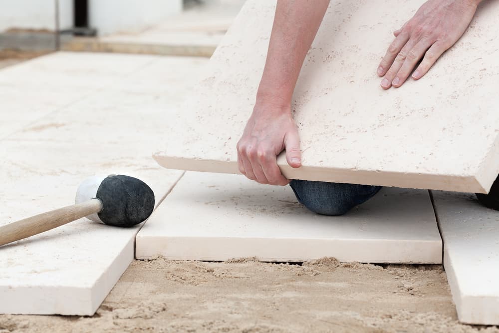 laying concrete paving slabs on sand